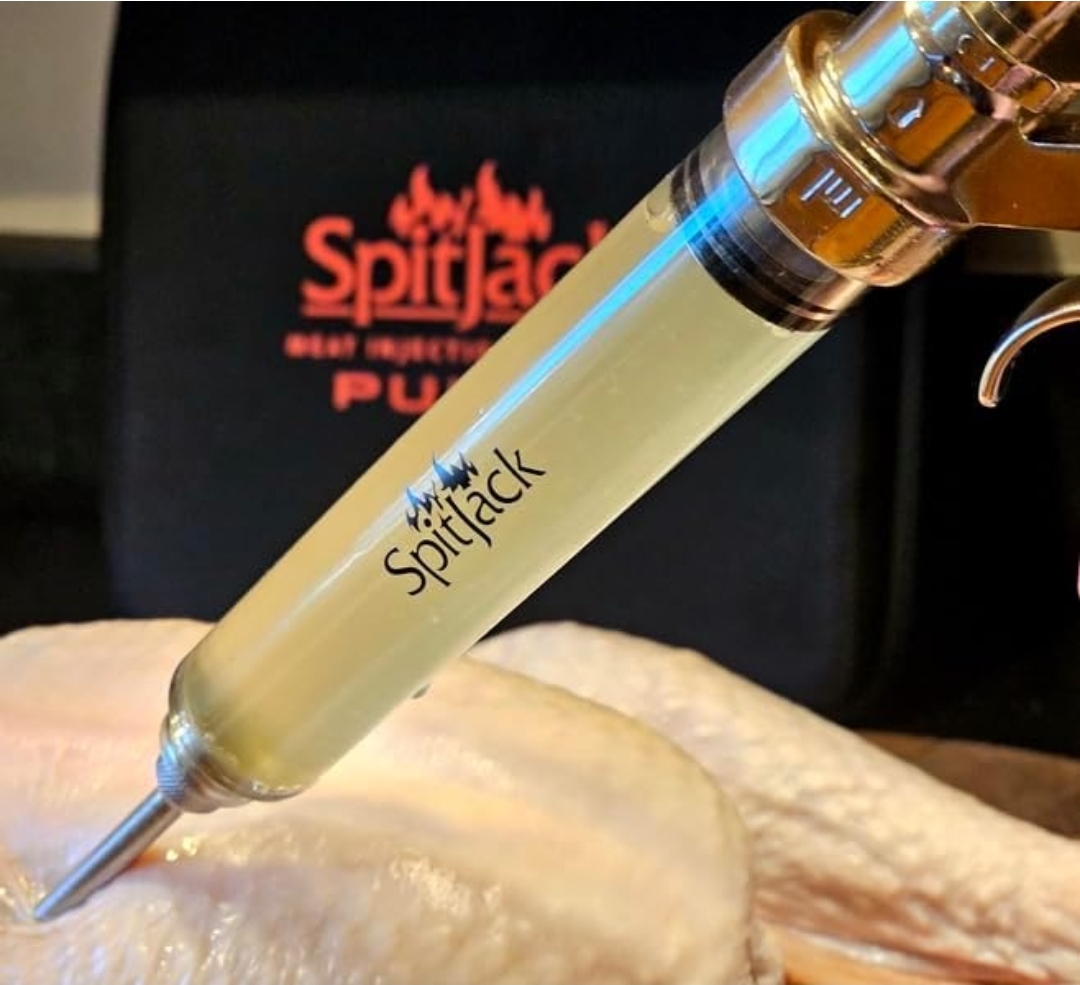 SpitJack Pulse meat injector injecting marinade into raw chicken